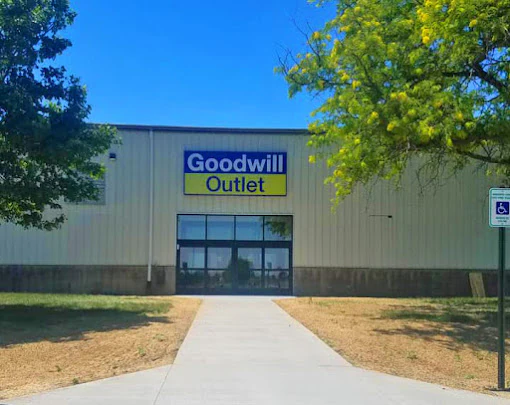 Goodwill Outlet Store in Cedar Rapids, Iowa, displaying a large open layout with rows of donation bins.